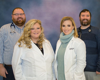 Taylor Regional Pediatrics Staff. There is two females and two males smiling.
