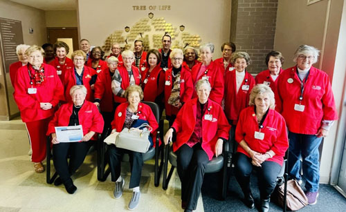 Taylor Regional Auxiliary Volunteer Staff standing in lobby area, taking a group picture.